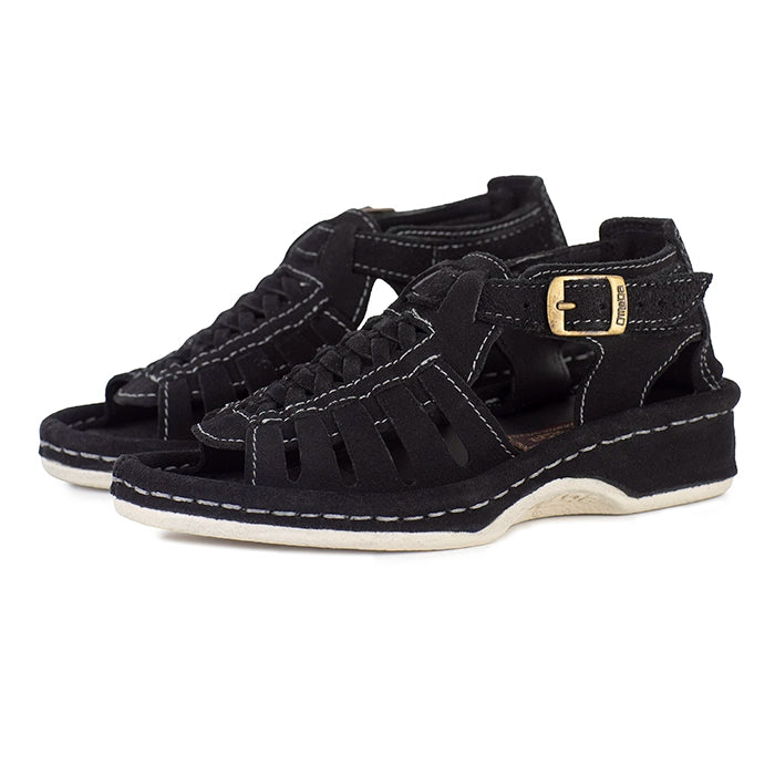 Black sandals with a gold buckle on a white background