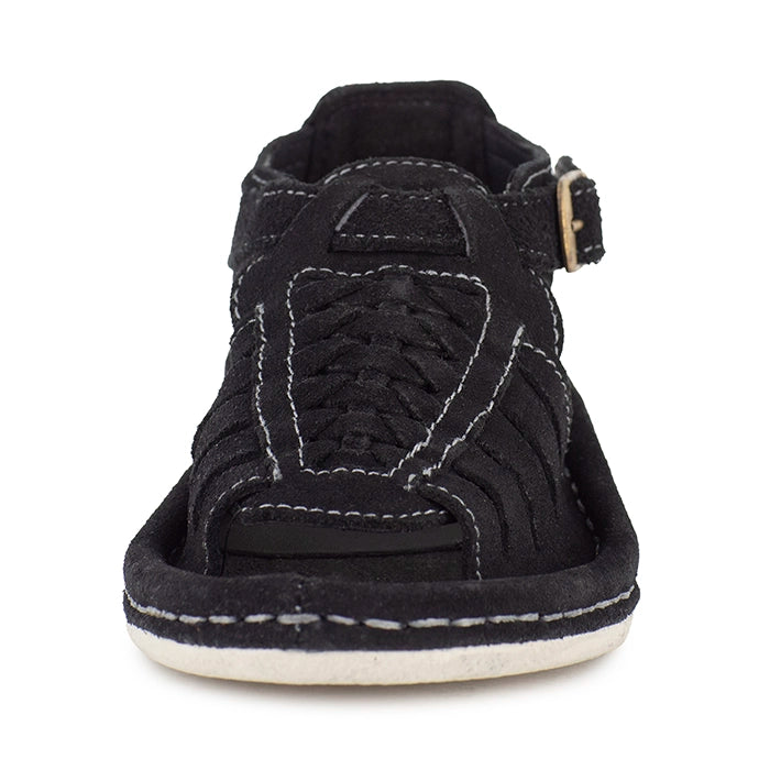 Black sandal with a gold buckle on a white background