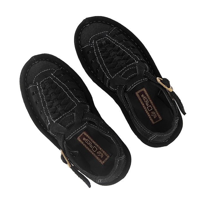 Black sandal with a gold buckle on a white background