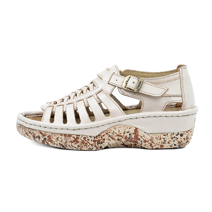 Cream sandal with a patterned sole on a white background