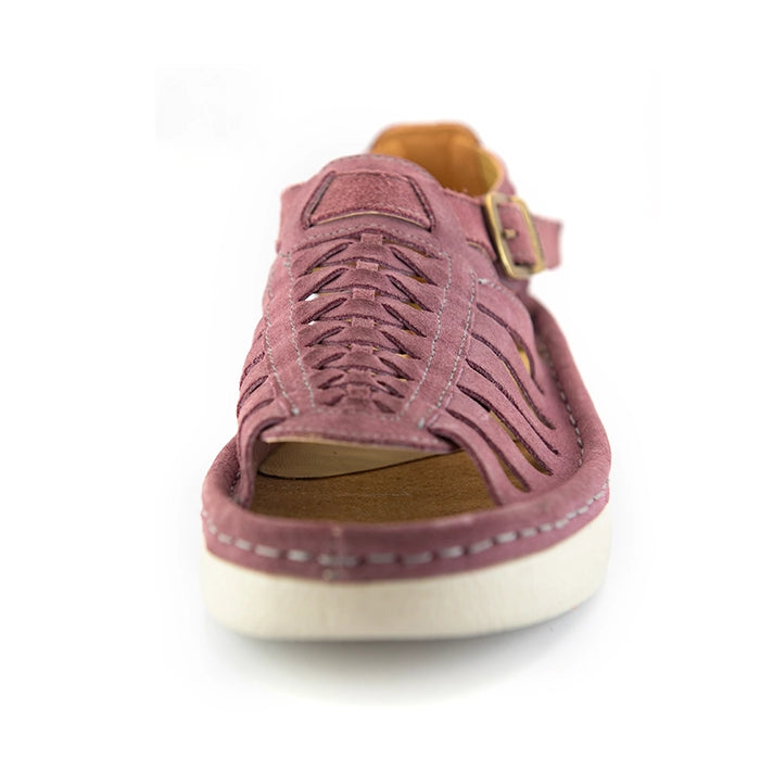 A single lilac suede wedge sandals with cutout straps, a buckle strap, and a beige sole, shown on a white background.