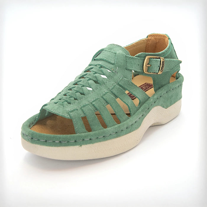 A pair of women's open-toe sandals in a mint suede, featuring cutout straps, a braided front design, adjustable ankle straps with silver buckles, and white soles.