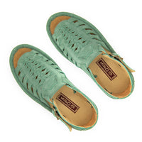 A pair of women's open-toe sandals in a mint suede, featuring cutout straps, a braided front design, adjustable ankle straps with silver buckles, and white soles.