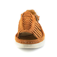 A single peach coloured suede wedge sandals with cutout straps, a buckle strap, and a beige sole, shown on a white background.