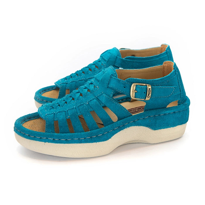 A pair of turquoise blue suede wedge sandals with cutout straps, a buckle strap, and a beige sole, shown on a white background.