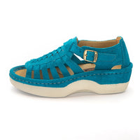 A turquoise blue suede platform sandal with cutout straps, a buckle strap, and a thick cream-colored platform sole, shown from a side profile on a white background.