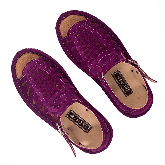 Pair of purple sandals on a white background