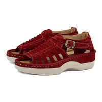 Red sandals with a off white sole on a white background