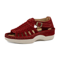 Red sandal with a off white sole on a white background