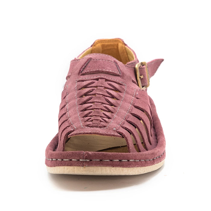 A single shoe with strappy sandals in lilac suede, featuring a cutout design, braided detail across the front, an adjustable ankle strap with a gold-tone buckle, and a low wedge heel. The brand 'Omega' is visible on the buckle.