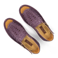 A pair of strappy sandals in purple suede, featuring a cutout design, braided detail across the front, an adjustable ankle strap with a gold-tone buckle, and a low wedge heel. The brand 'Omega' is visible on the buckle.