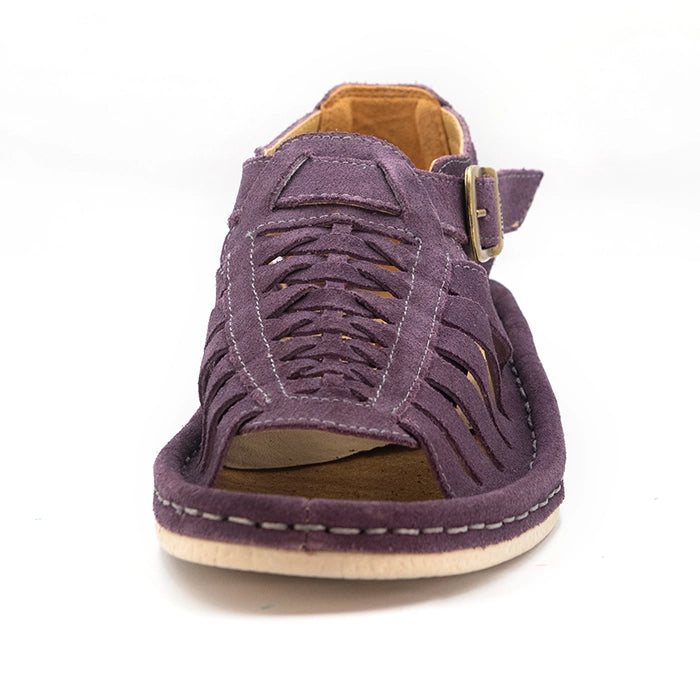 A shoe with strappy sandals in purple suede, featuring a cutout design, braided detail across the front, an adjustable ankle strap with a gold-tone buckle, and a low wedge heel. The brand 'Omega' is visible on the buckle.