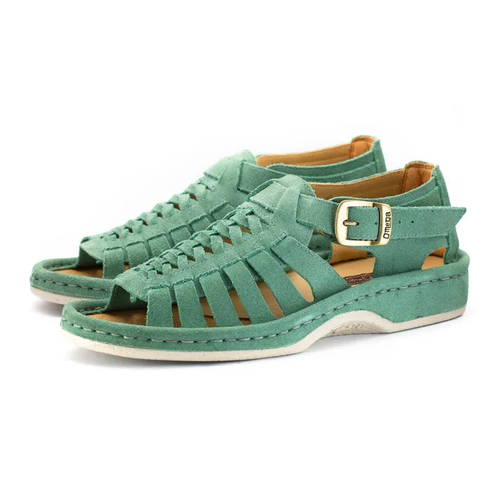 A pair of mint green cut-strap platform sandals with a buckle strap on the ankle, shown on a white background.