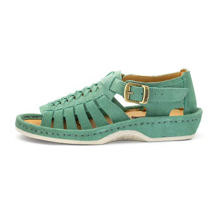 A mint green suede wedge sandal with a multi-cut strap design, a gold buckle, and a white sole, shown in a side profile on a white background.