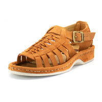 A single sandal in peach coloured suede, featuring a multi-cut strap design, an adjustable ankle strap with a gold-tone buckle, and a thick white sole.