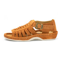 A single sandal in peach coloured suede, featuring a multi-cut strap design, an adjustable ankle strap with a gold-tone buckle, and a thick white sole.