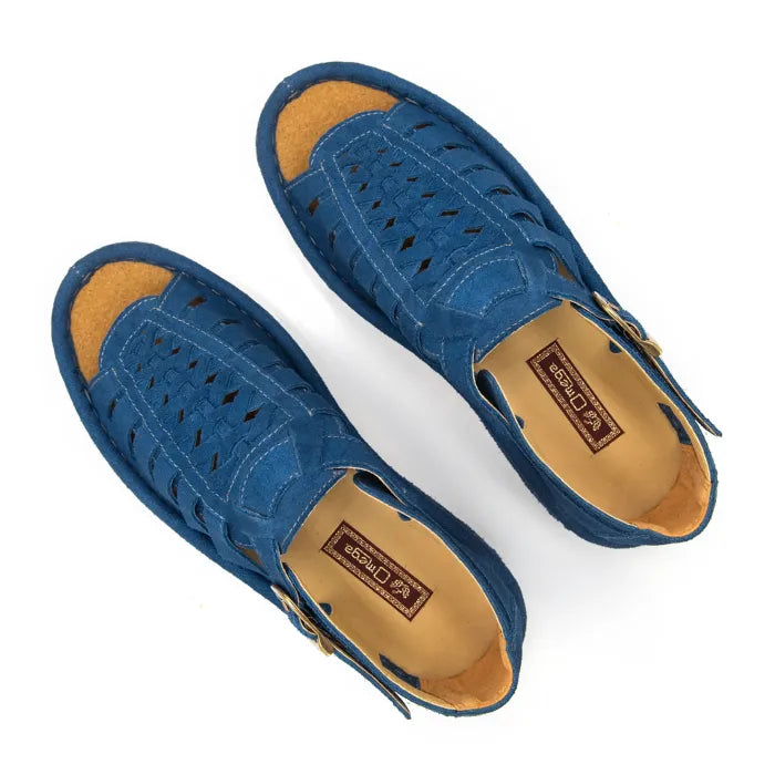 A pair of sandals in royal blue suede, featuring a multi-cut strap design, an adjustable ankle strap with a gold-tone buckle, and a thick white sole.