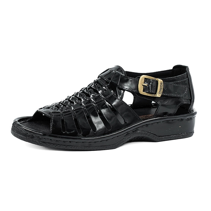Black sandal with a gold buckle on a white background