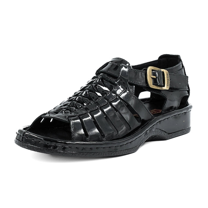 Black sandal with a gold buckle on a white background