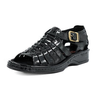 Black sandal with a gold buckle on a white background
