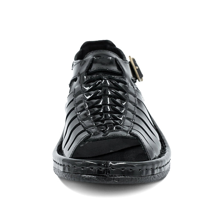 Black sandal with a strap on a white background