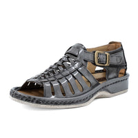 Grey sandal with a buckle on a white background