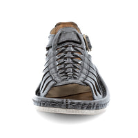 Grey sandal with off white sole on a white background