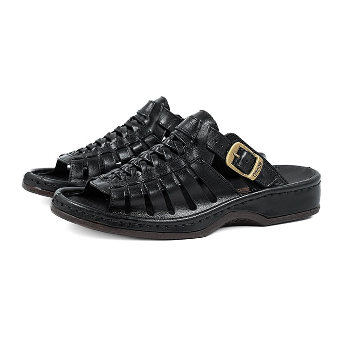 Black slip-on sandals with a gold buckle on a white background
