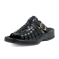 Black sandal with a gold buckle on a white background
