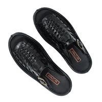 Pair of black sandals with brand logo on a white background
