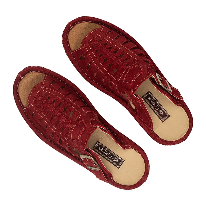 Pair of red sandals with a brand label on a white background