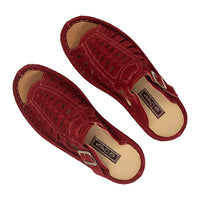 Pair of red sandals with a brand label on a white background