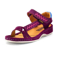 A single women's sandal in cerise suede with magenta braided strap details, a tan footbed, and a white sole, shown on a white background.