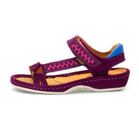 A single women's sandal in cerise suede with a pink woven pattern on the straps, a white sole, and a blue heel accent, shown against a plain white background.