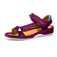 A single women's sandal in cerise suede with a pink woven patterned strap, tan insole, and a blue heel accent, shown on a white background.