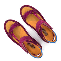 A pair of women's sandals with cerise suede straps, a bright orange-yellow footbed, and a blue outsole edge, shown from a top-down angle on a white background.