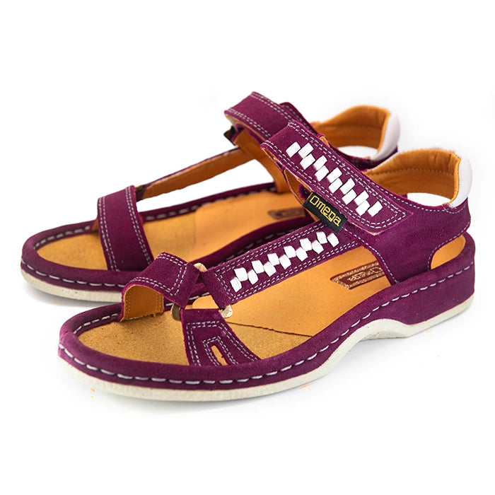 A pair of women's sandals in deep cerise suede with woven pattern details on the straps, a tan interior, and grey heel accents, shown on a white background.