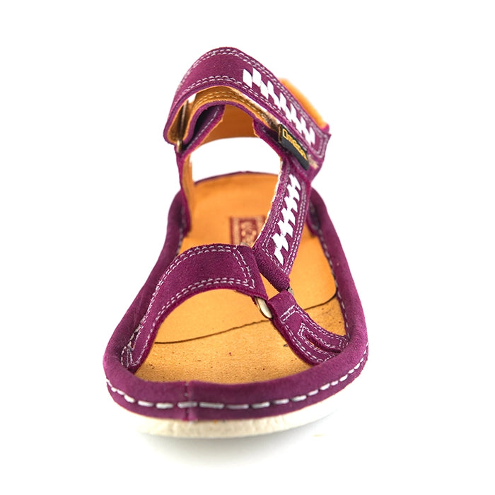 A single women's sandals in deep cerise suede with woven pattern details on the straps, a tan interior, and grey heel accents, shown on a white background.