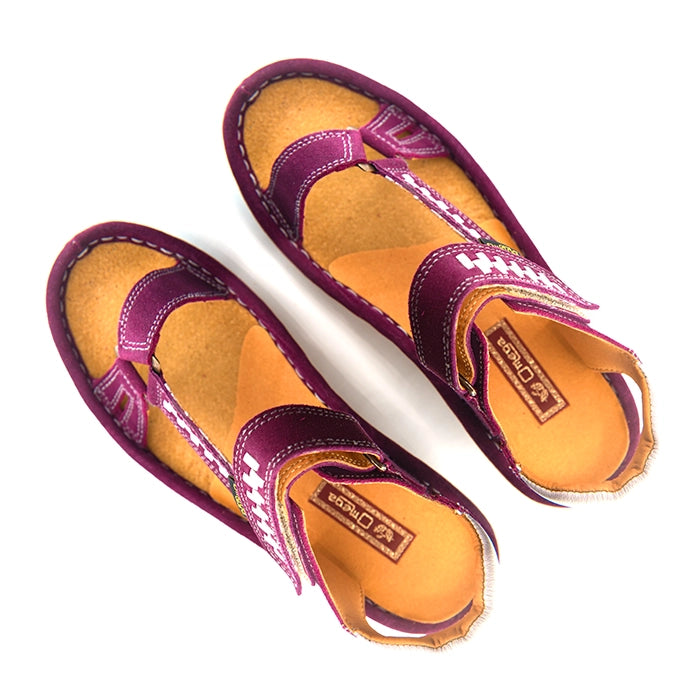 A pair of women's sandals in deep cerise suede with woven pattern details on the straps, a tan interior, and grey heel accents, shown on a white background.