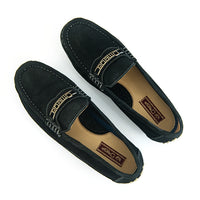 A pair of black suede driving loafers with gold embroidered 'Omega' logos on the vamp, displayed on a clean white background.