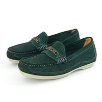 A pair of dark green suede penny loafers with a gold-tone metal bar across the vamp and a cream-colored sole, shown on a white background.