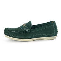 A dark green suede penny loafer with a small gold-tone metal logo on the strap, set against a plain white background.