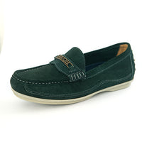 A dark green suede loafer with a decorative strap featuring an Omega logo with gold lettering, shown on a white background.